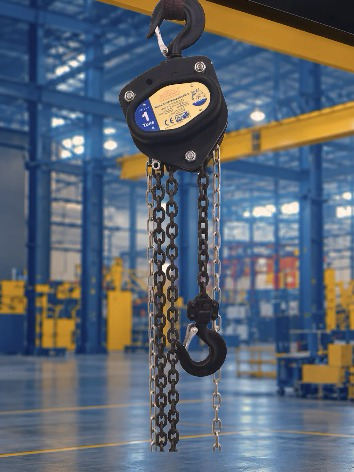 Black manual chain pulley block with hooks and load chain in a factory